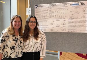 Lauren E. Zangara with their 2022 Penn State Psi Chi poster and Dr. Kristin Buss.