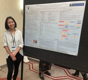 Yeunjoo Vanessa Kim standing next to her research poster.
