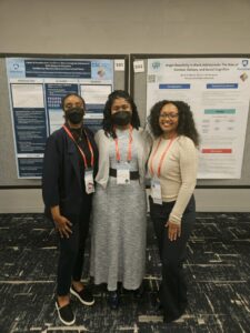 Tiyobista Maereg, Dr. Dawn Witherspoon, and Briah Glover standing next to research poster
