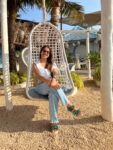 Rhea Sarma sitting on a swing