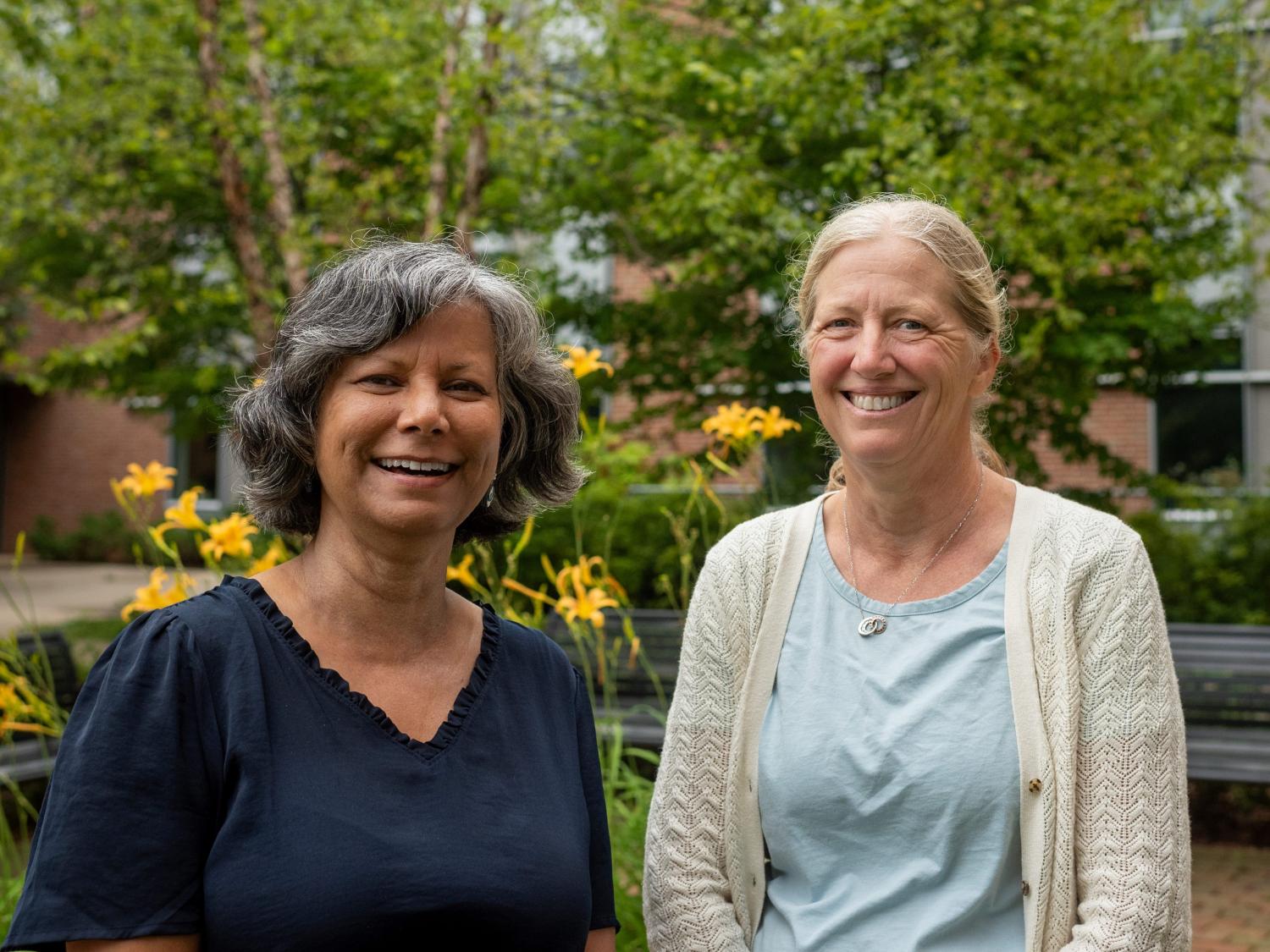 Rina Das Eiden and Jenae Neiderhiser standing outside.