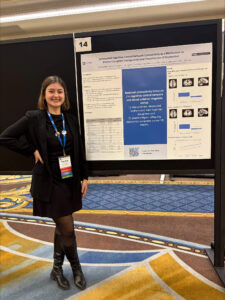 Eda Naz Dinc standing next to 2025 ADAA conference poster