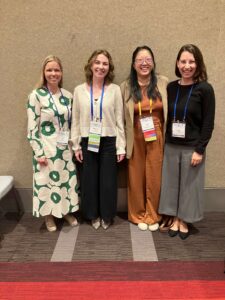 Fiia Takio, Ph.D., Madison Kelm, M.S., Anna Zhou, Ph.D., & Tess Forest, Ph.D., standing next to each other to pose for a picture at SRCD 2025