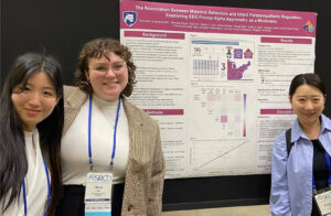 Sua Cho, Olivia Bell, and Eunkyung Shin standing with 2025 SRCD poster