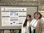 Sua Cho and Olivia Bell standing next to 2025 SRCD poster