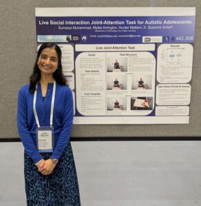 Sumaiya Muhammad standing with poster at INSAR 2025