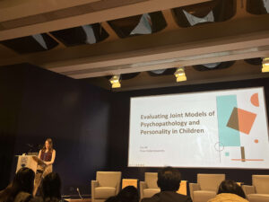 Katherine All standing behind a podium while presenting at ISRCAP 2025